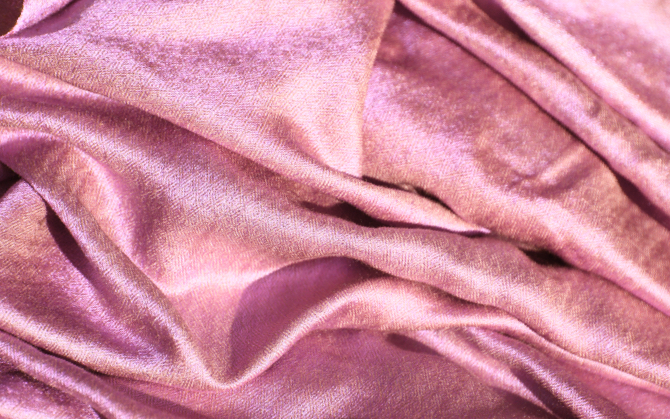 a top down view of a pink wrinkled cloth