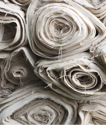 a front facing view of a stack of rolled up fabric